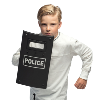 Boy holding a police shield with viewing window. The shield reads 'police'.
