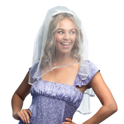 A smiling woman in a purple dress with flowers has a veil on which is attached in her hair with a hair comb.