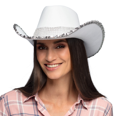 A smiling woman with long black straight hair wears a white cowboy hat with silver sequin brim and a band of shiny stones.