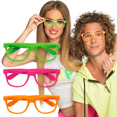 Woman wearing neon green glasses, next to her is a man wearing neon orange glasses. Both glasses are without lenses. To the left of the couple, you can see 3 neon glasses in green, orange and yellow.