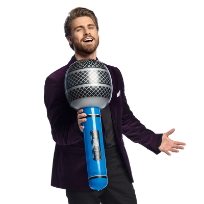 Man holding a large inflatable microphone with blue handle.