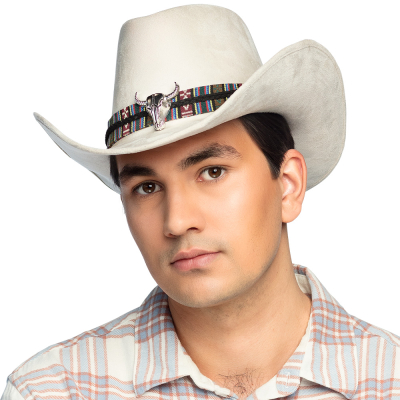 Man with flannel checked shirt has a beige cowboy hat on with a fabric band with wild west pattern and silver bulls head as details.