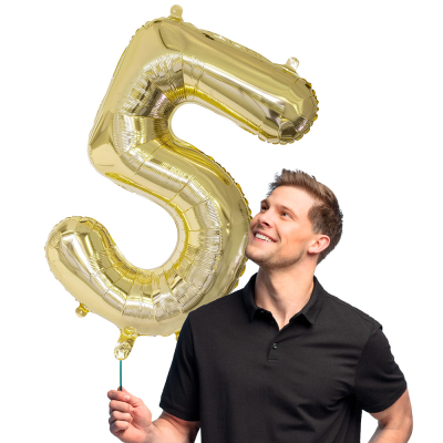 Gold foil balloon in the shape of the numeral 5.