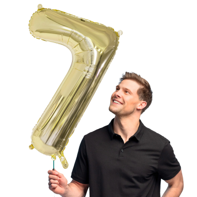 Gold foil balloon in the shape of the numeral 7.