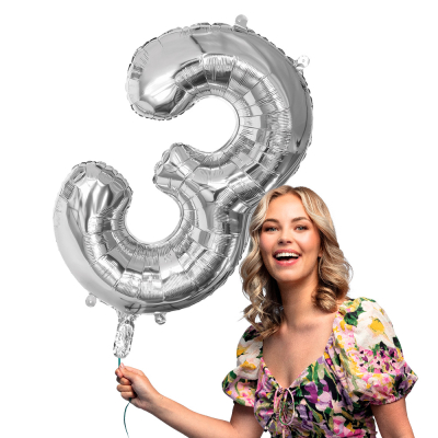 Silver foil balloon in the shape of the numeral 3.
