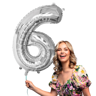Silver foil balloon in the shape of the numeral 6.