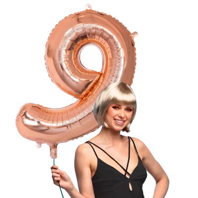 Pink gold foil balloon in the shape of the number 9.