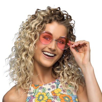 Woman wearing large round hippie glasses with pink lenses.