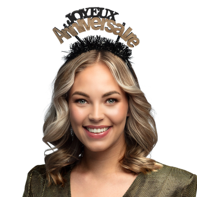 Woman wearing a black tiara with the text Joyeux Anniversaire in black/ gold and glitter.