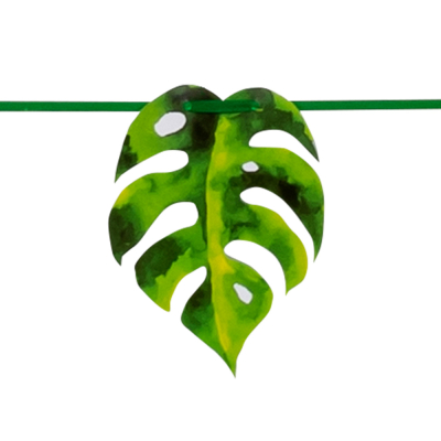 Part of a garland with a monstera palm leaf attached to a green ribbon.