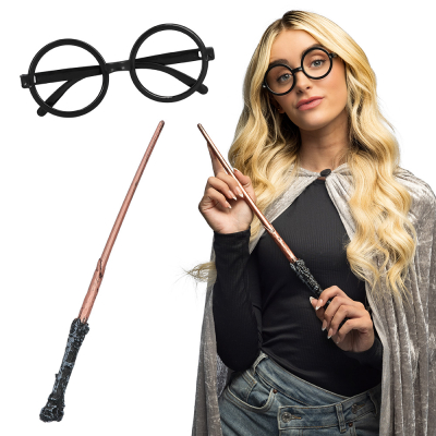 Une femme habillée en magicienne porte les lunettes de fête rondes sans lunettes et tient la baguette magique de l'ensemble d'accessoires de magicienne.