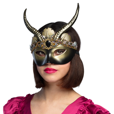 Woman wearing a bronze voodoo eye mask with horns.