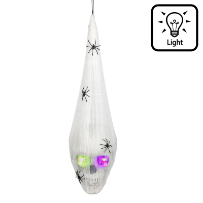 Halloween decoration of a skull with glowing eyes, wrapped with cobweb on which are several spiders.