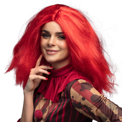 Smiling woman wearing a horror clown costume and a messy mid-length red wig with light waffle curls in it.