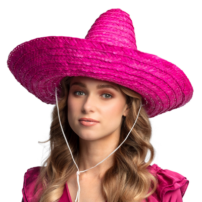Woman wearing a large sombrero hat in fuchsia, with drawstring.