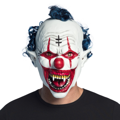 Man wearing a Halloween latex mask of a vampire clown with white face, blue curly hair, red edges around the eyes and mouth, a red nose and sharp fangs.