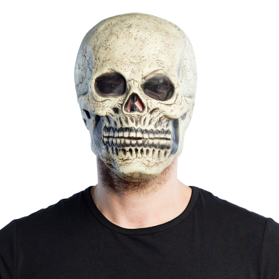 Man wears a halloween latex mask of a skull.