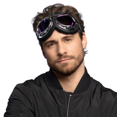 A man with blonde hair wears a cool black bomber jacket and has black silver retro look aviator glasses with soft rims on his forehead as an accessory.