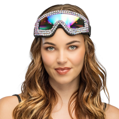 A woman is wearing party ski goggles with mirrored lenses and sparkling stones on her forehead for a cool rave party look.