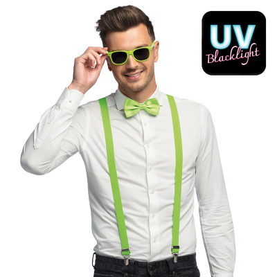 Smiling man wears a white blouse with dark jeans combined with a neon green accessory set consisting of green party glasses, bow tie and braces.
