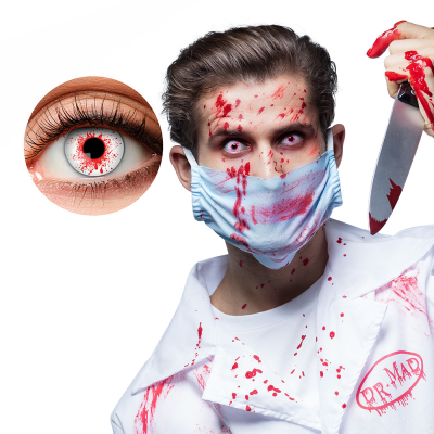 Eye with white Halloween lens with blood splatters. Around the eye are also blood splatters.