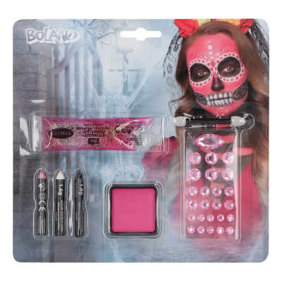 Schminkset voor Day of the Dead. Blisterverpakking met een print van een vrouw geschminkt als felroze doodshoofd met diamantjes. De verpakking bestaat uit schmink, schminksticks, een applicator, glittergel en een vel strass steentjes