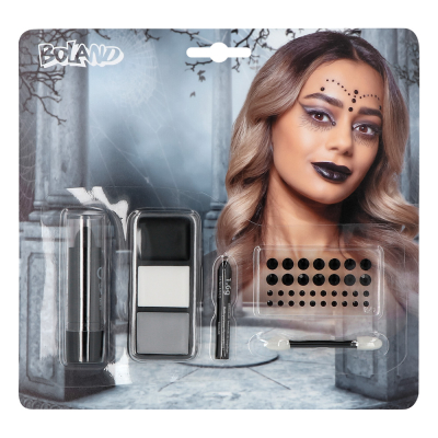 Schminkset voor gothic heks. Blisterverpakking met een print van een vrouw met donkere make-up en zwarte lippenstift. De verpakking bestaat uit vetschmink, lippenstift, een vel strass steentjes en een applicator.