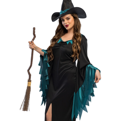 A woman wears a witch costume and holds in her hand a witch's broom with wound handle as an accessory to her outfit.