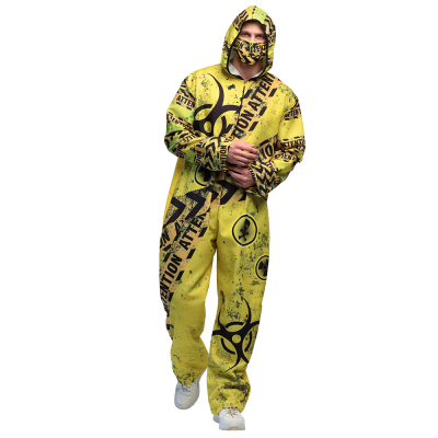 Man wearing a yellow radioactive overalls with hood and a mouth mask. This Halloween costume is printed with symbols of radioactivity, skulls and 'attention'.