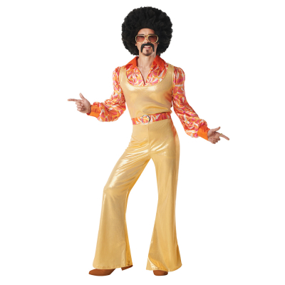 A man wears a 70's/80's style disco costume with gold long trousers, matching gold blouse, a shirt with retro print and matching belt.