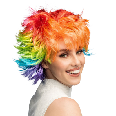 A woman wears a short, wild wig in bright rainbow colours.